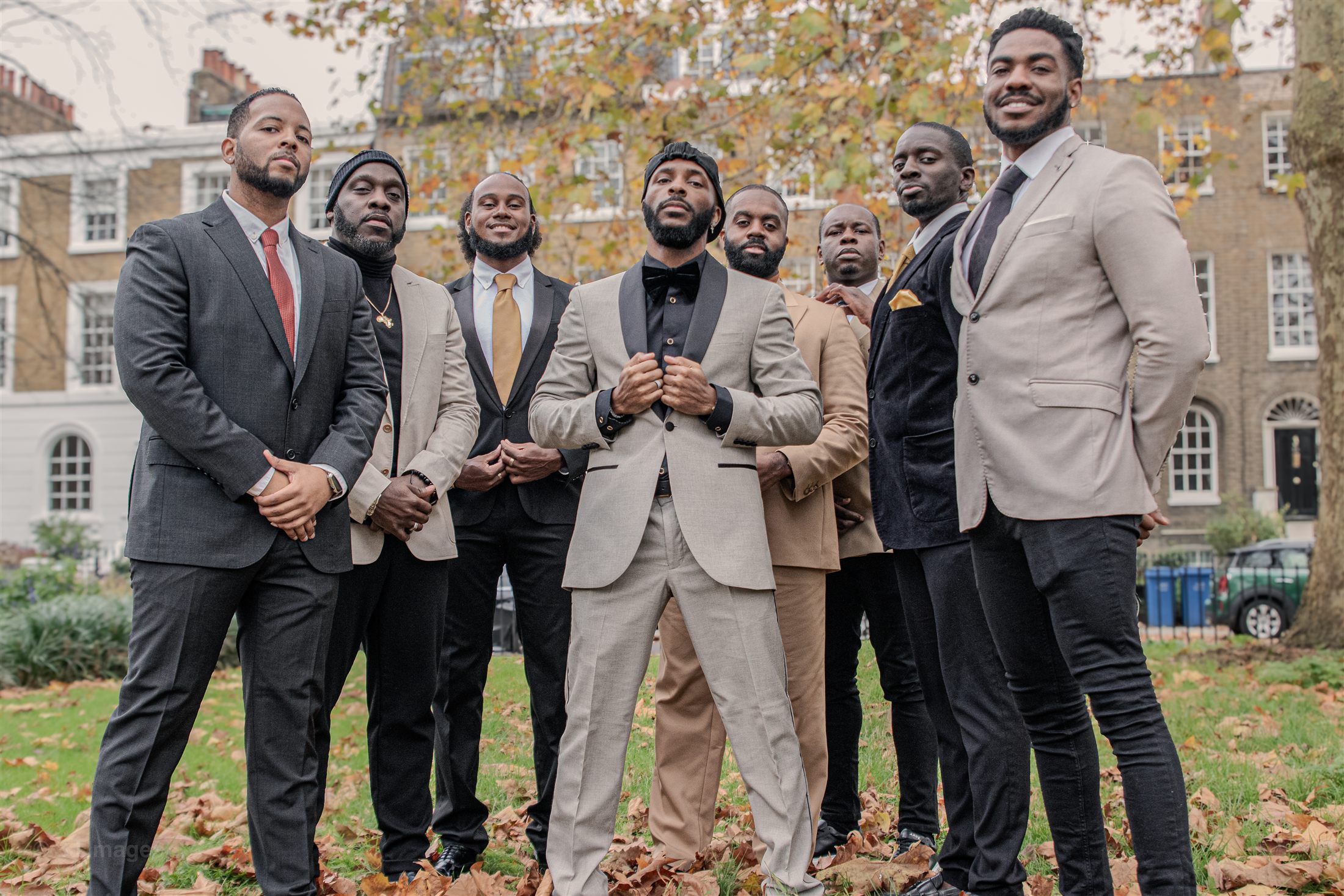 Eight KVG members standing together outdoors in formal dress